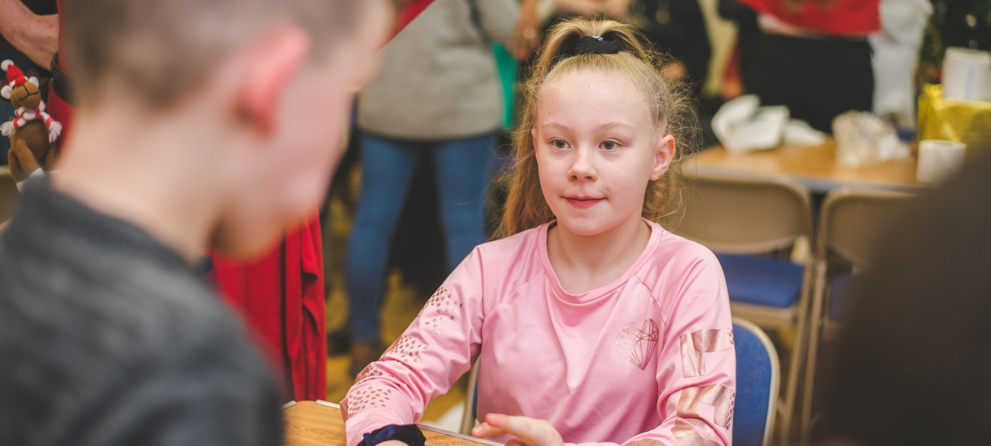 Young girl talking to another child